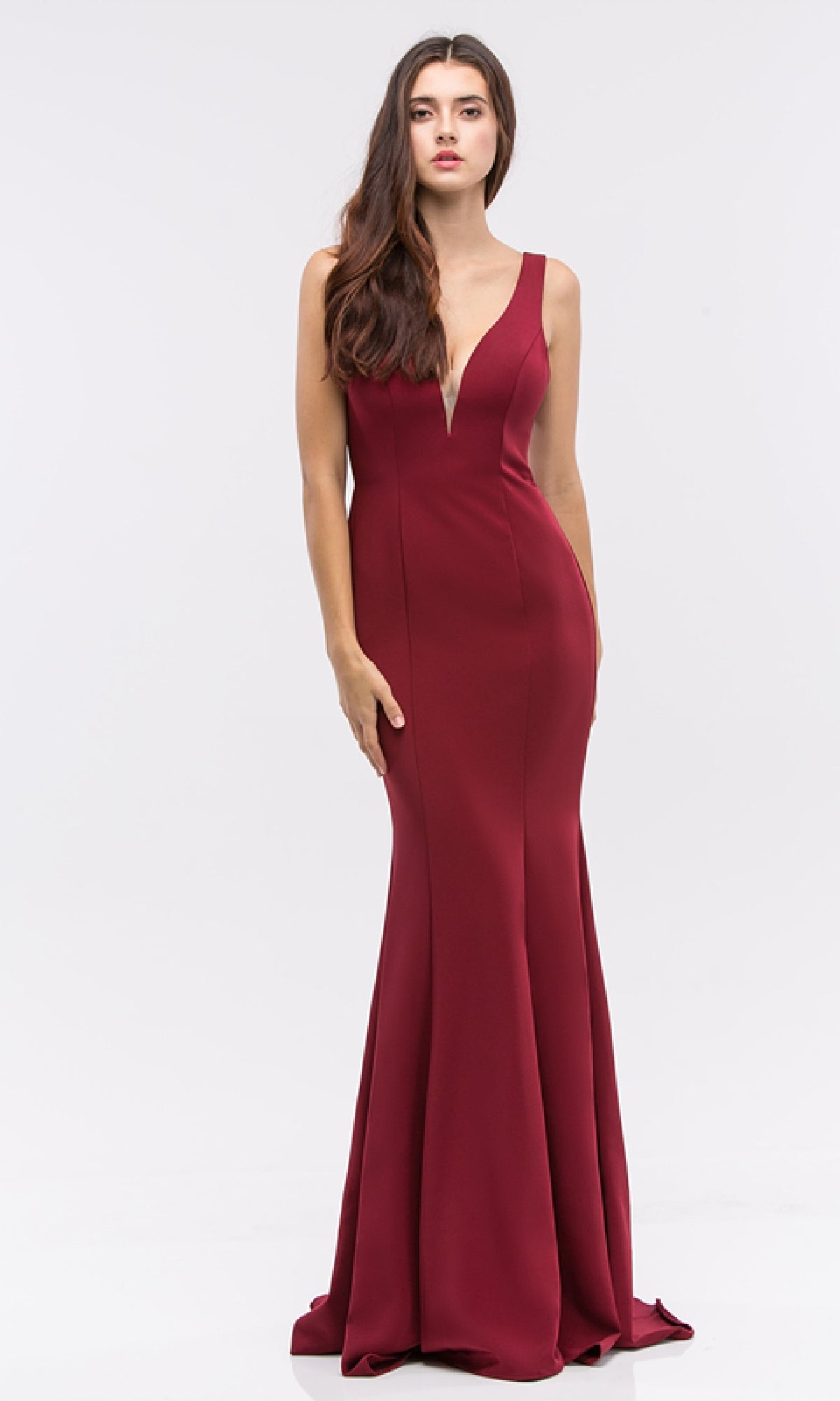 A woman wearing the Classic Long V-Neck Satin Prom Dress (Eureka 6010) in deep red, a sleeveless, floor-length gown with a plunging neckline, stands against a plain light background.